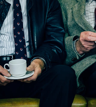 Two old men enjoying decaf coffee portrait orientation